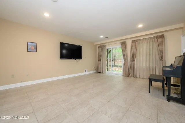 a view of a livingroom with furniture and a flat screen tv