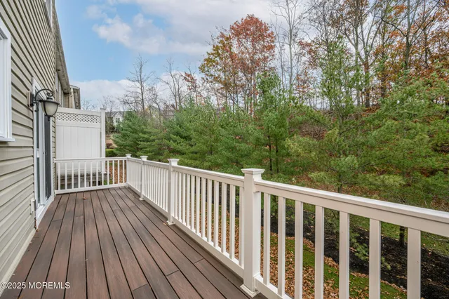 a view of a wooden deck with large trees