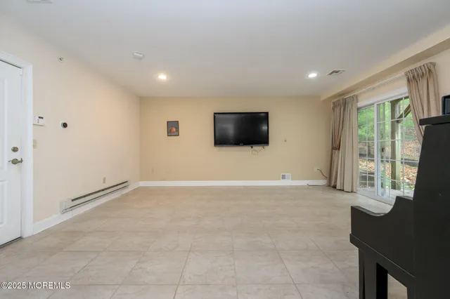 a view of an empty room with a flat screen tv