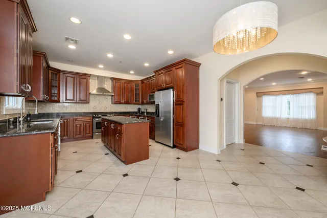 a kitchen with stainless steel appliances granite countertop a stove and a refrigerator