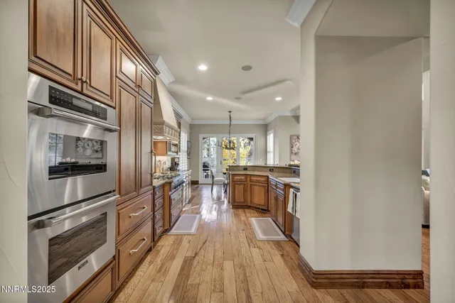 a view of a dining room with furniture and a chandelier