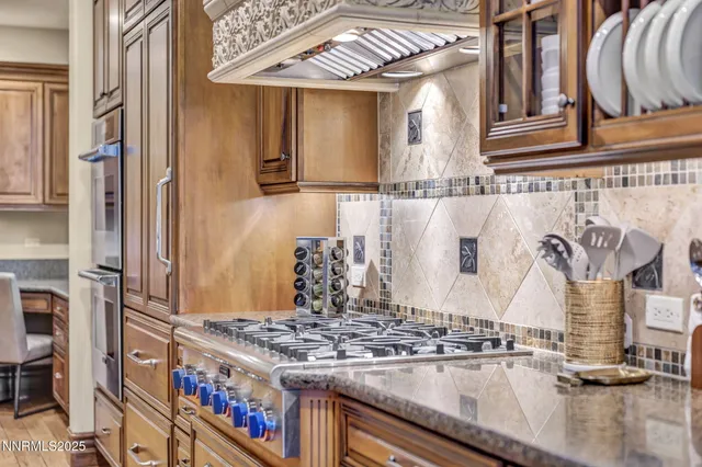 a view of a dining room with furniture a chandelier and wooden floor