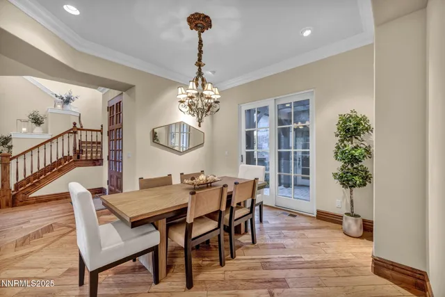 a living room with furniture a chandelier and a flat screen tv