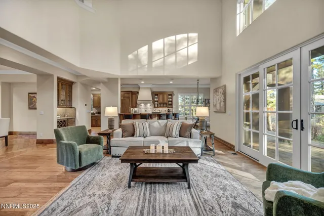 a kitchen with stainless steel appliances granite countertop a stove top oven a sink with wooden cabinets and wooden floor