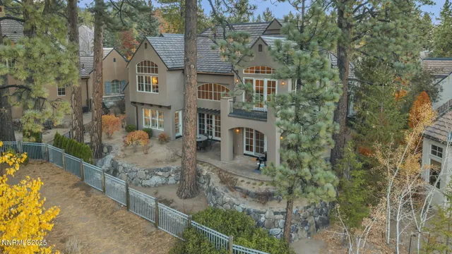 a kitchen with stainless steel appliances granite countertop a kitchen island a stove a sink a dining table and chairs with wooden floor