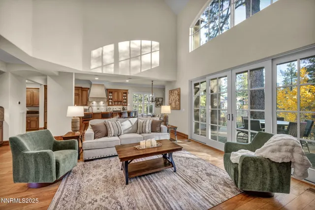a spacious bedroom with a bed and a flat tv screen on wall