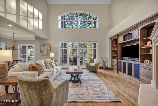 a bedroom with a large bed and wooden floor