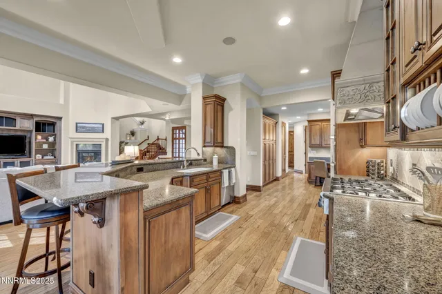 a kitchen with stainless steel appliances granite countertop a refrigerator and a sink