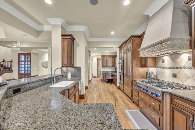 a kitchen with stainless steel appliances granite countertop lots of counter top space and wooden floor