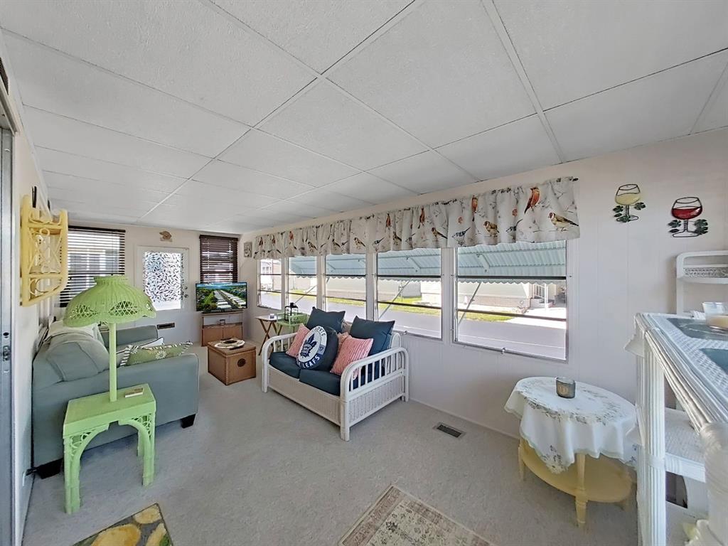9900 Ulmerton Road, Unit 238 Largo, FL 33771 - Photo 11 of 22 a view of a livingroom with furniture and a large window