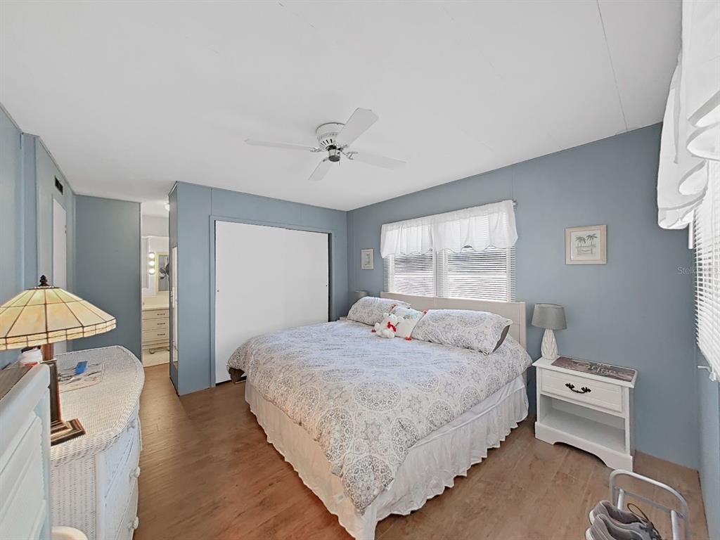 9900 Ulmerton Road, Unit 238 Largo, FL 33771 - Photo 13 of 22 a bedroom with a bed and a chandelier