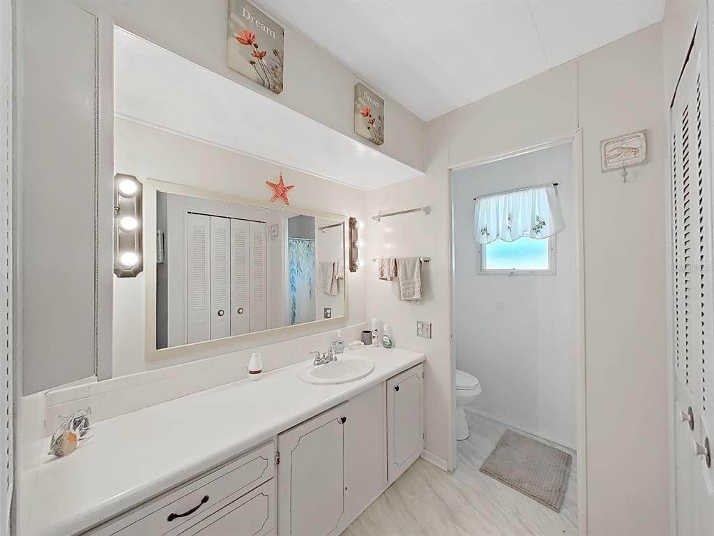 9900 Ulmerton Road, Unit 238 Largo, FL 33771 - Photo 14 of 22 a bathroom with a sink a toilet and shower