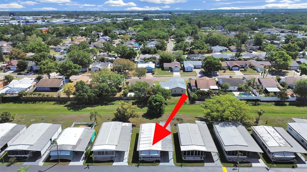 9900 Ulmerton Road, Unit 238 Largo, FL 33771 - Photo 2 of 22 an aerial view of a houses with a yard and lake view