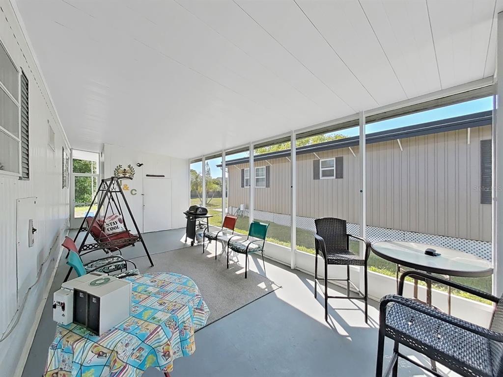 9900 Ulmerton Road, Unit 238 Largo, FL 33771 - Photo 4 of 22 a living room with furniture a air conditioner vent and a window