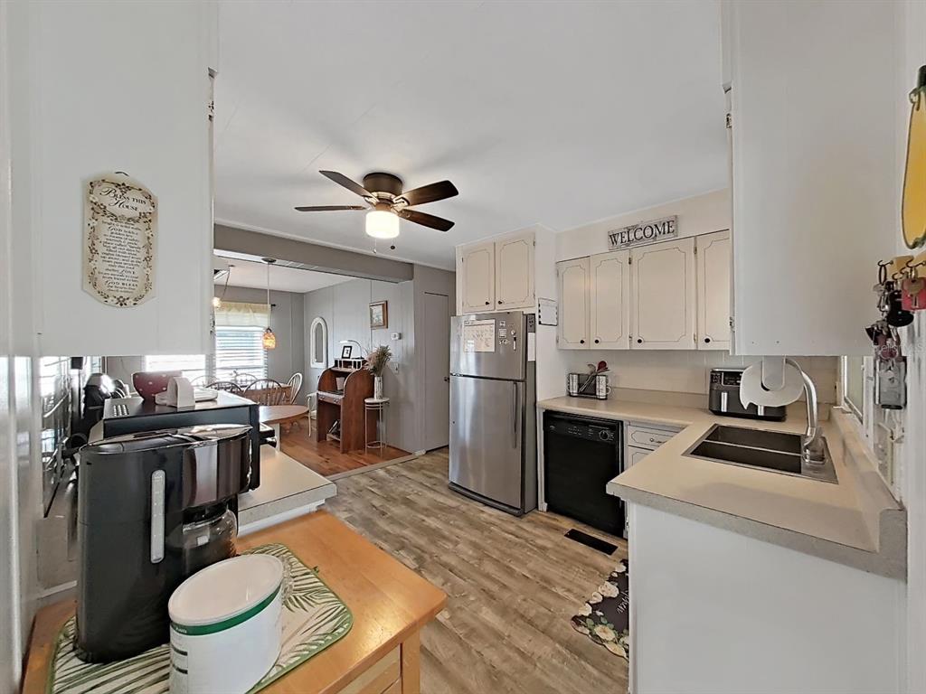 9900 Ulmerton Road, Unit 238 Largo, FL 33771 - Photo 6 of 22 a kitchen with a stove a refrigerator and a dining table