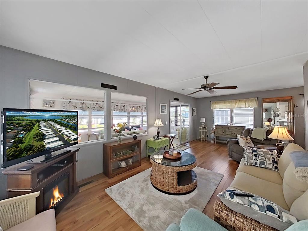 9900 Ulmerton Road, Unit 238 Largo, FL 33771 - Photo 10 of 22 a living room with furniture and a flat screen tv