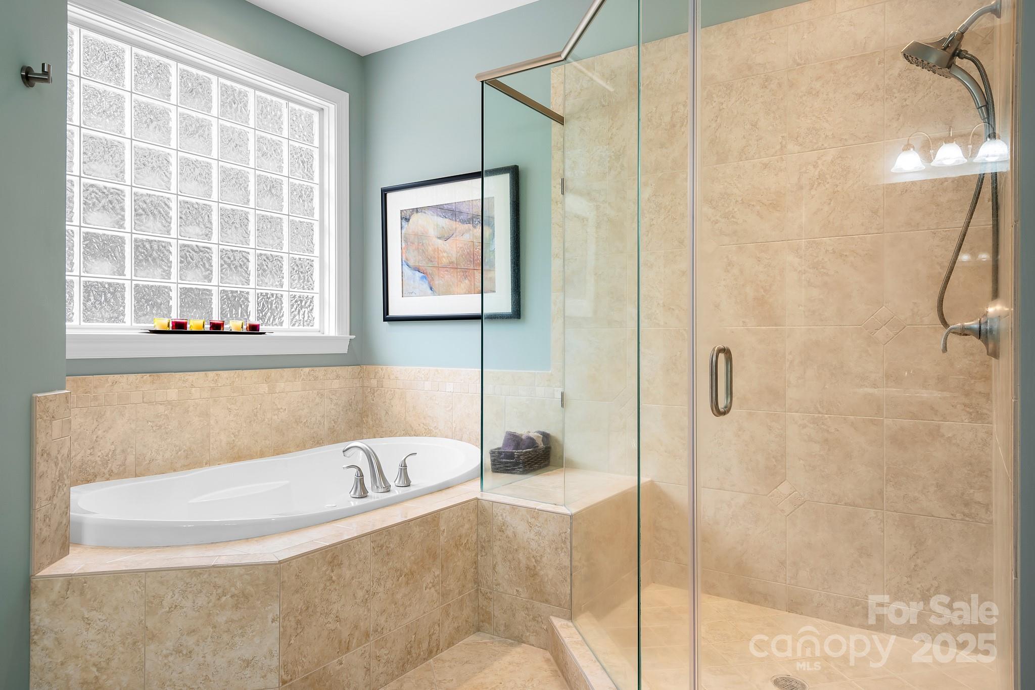 302 McCrary Road Mooresville, NC 28117 - Photo 15 of 34 a bathroom with a bathtub and a shower