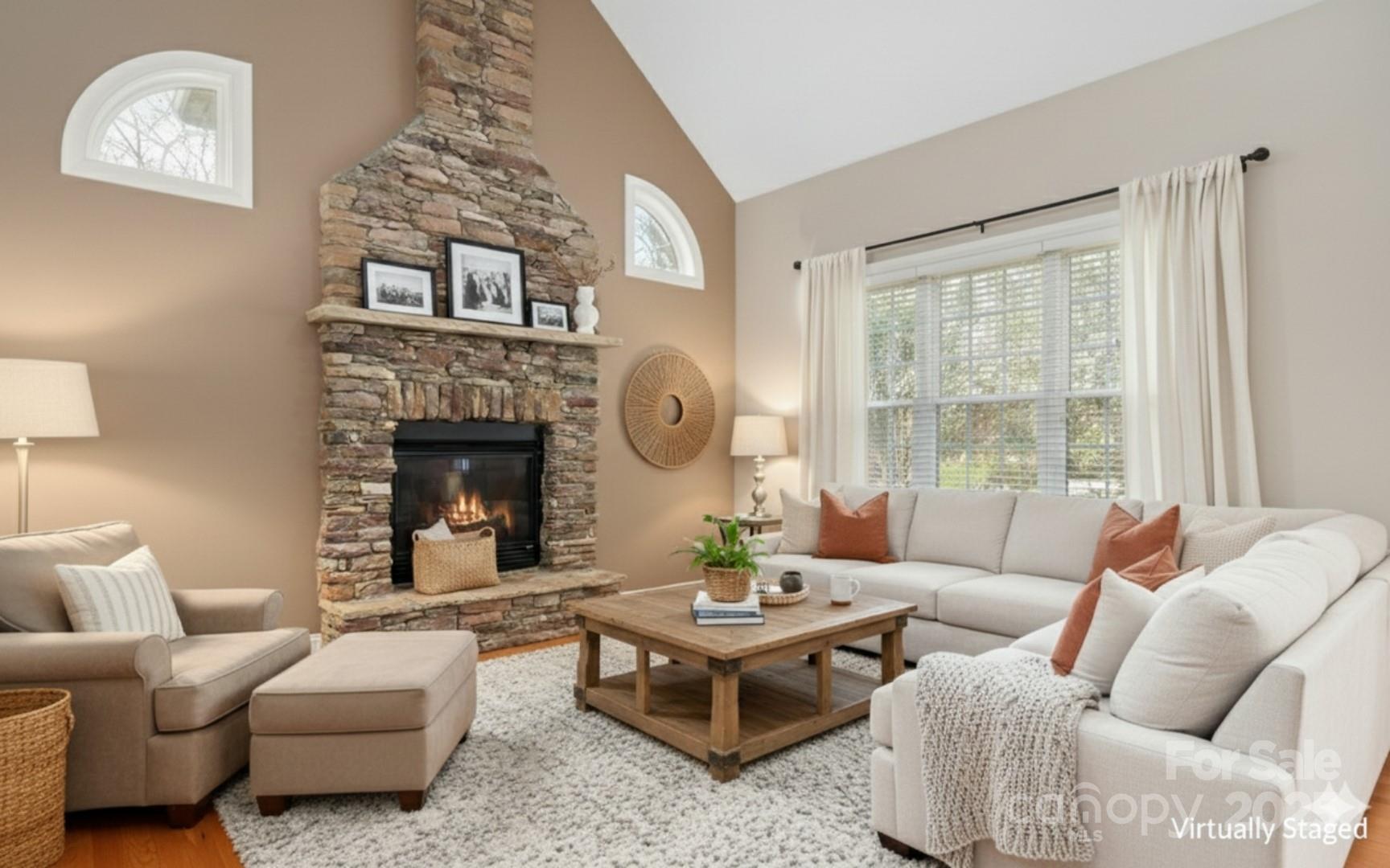 302 McCrary Road Mooresville, NC 28117 - Photo 6 of 34 a living room with furniture a rug and a fireplace