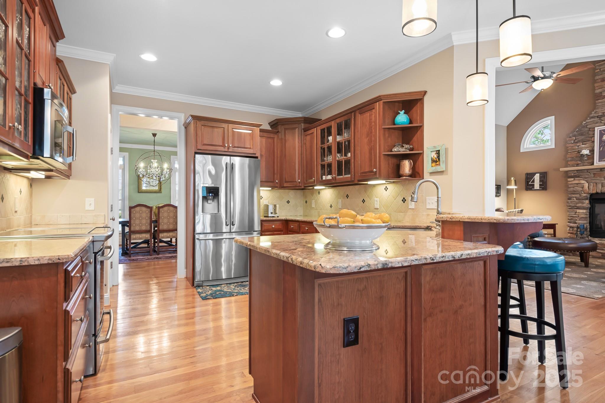 302 McCrary Road Mooresville, NC 28117 - Photo 7 of 34 a kitchen with stainless steel appliances granite countertop a refrigerator a stove and a sink with wooden floor