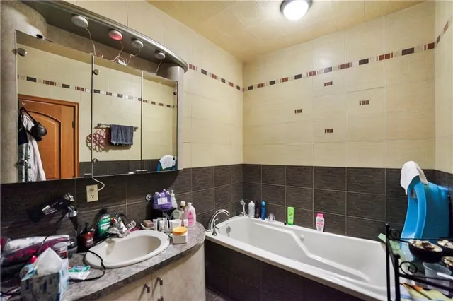 a bathroom with a sink double vanity and a mirror