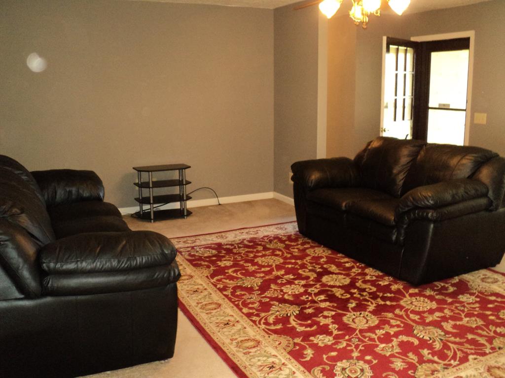 74 Kitetown Loop Seale, AL 36875 - Photo 9 of 28 a living room with a couch and a dresser with wooden floor
