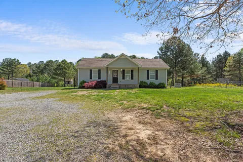 a front view of house with yard and green space