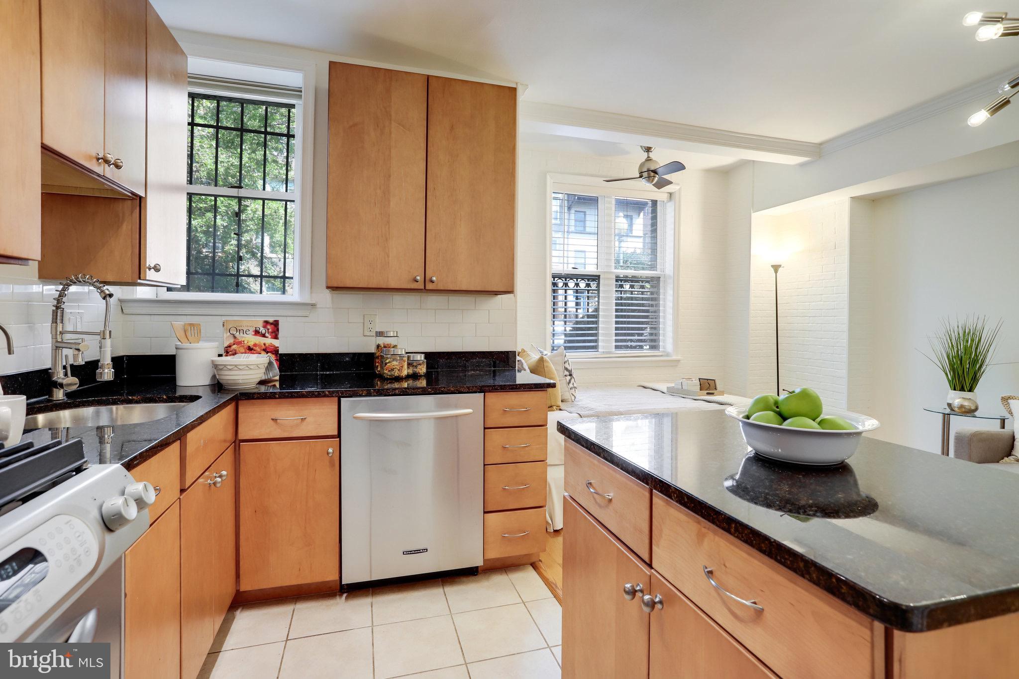 1438 Columbia Road Northwest, Unit 101 Washington, DC 20009 - Photo 18 of 39 a kitchen filled with white cabinets and window