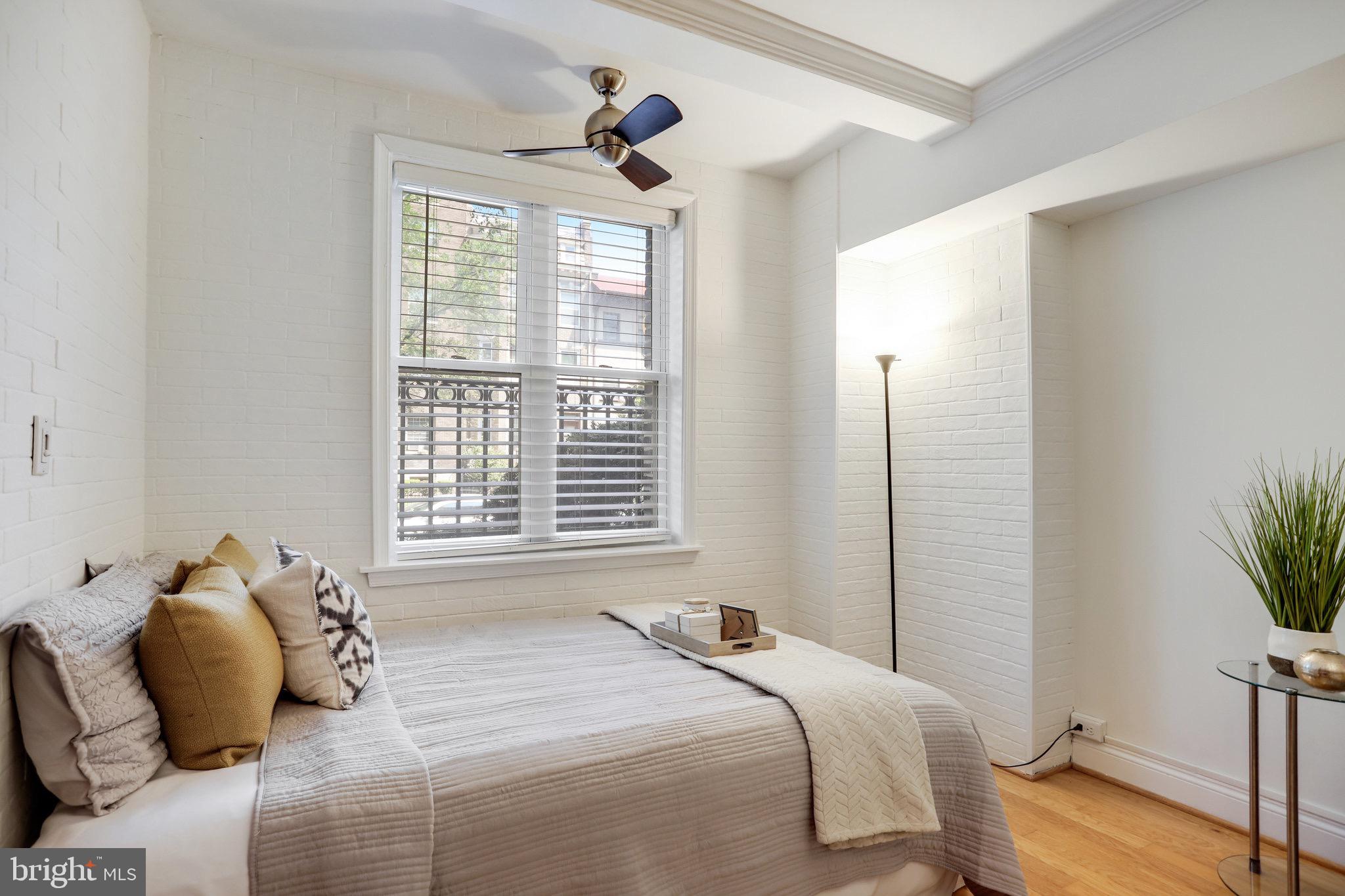 1438 Columbia Road Northwest, Unit 101 Washington, DC 20009 - Photo 22 of 39 a bedroom with a bed and a potted plant