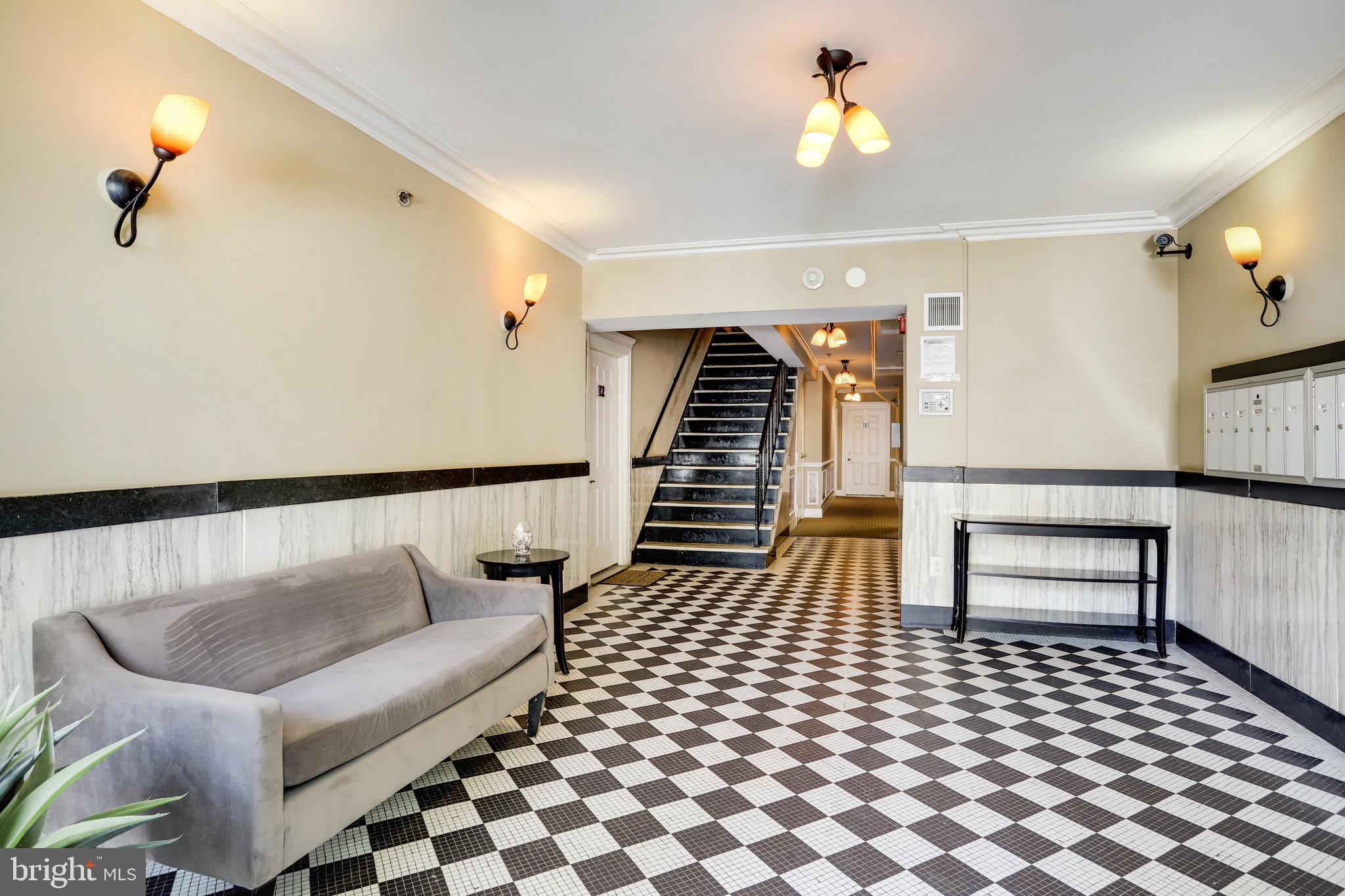 1438 Columbia Road Northwest, Unit 101 Washington, DC 20009 - Photo 27 of 39 a living room with furniture and a lamp