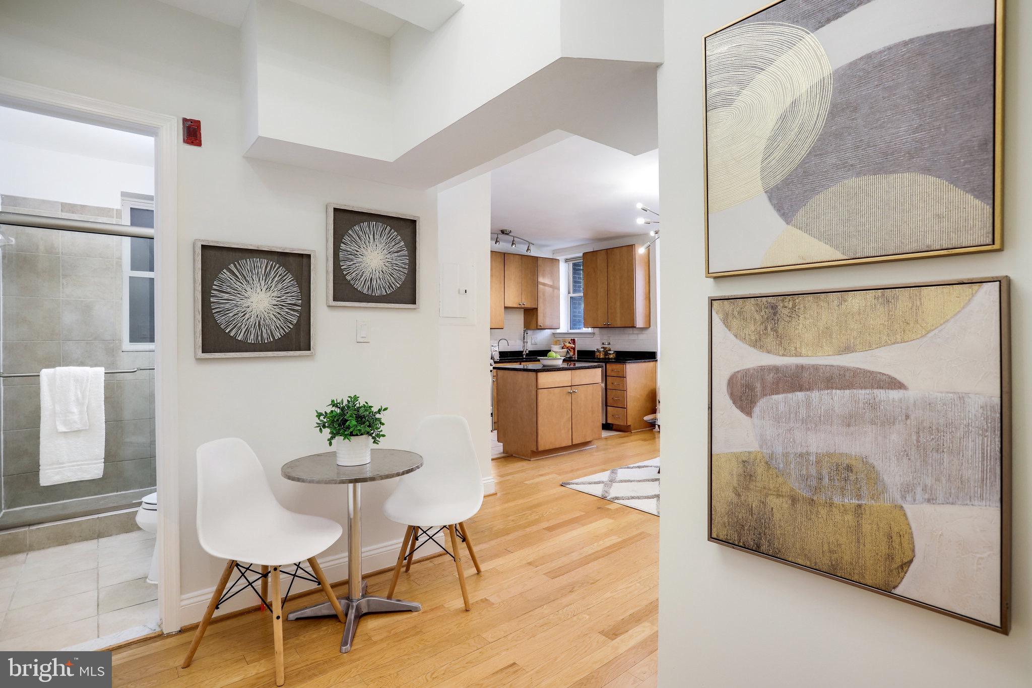 1438 Columbia Road Northwest, Unit 101 Washington, DC 20009 - Photo 8 of 39 a living room with furniture and a painting on the wall