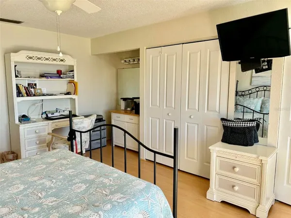 a bedroom with a bed and flat screen tv