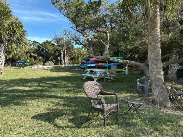 a backyard of a house with table and chairs
