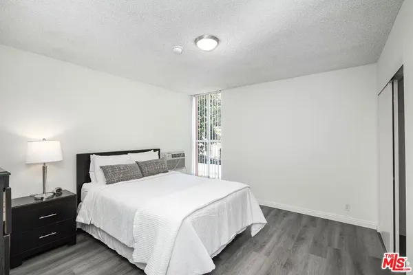 a bedroom with a bed and a night stand
