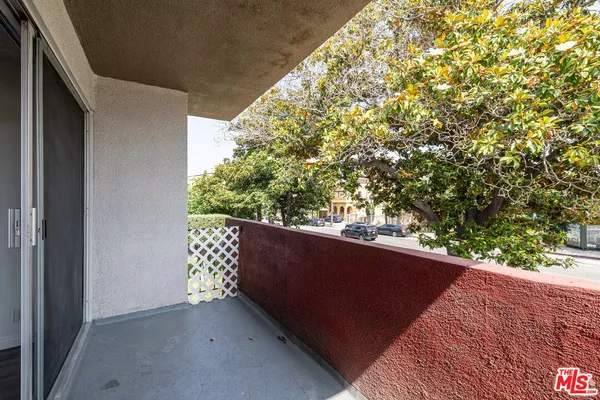 a view of balcony with a plant in front of it