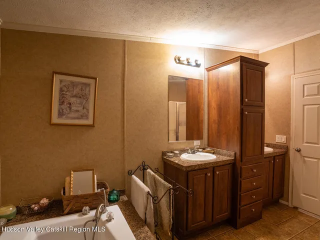 a bathroom with a granite countertop sink a toilet and a mirror