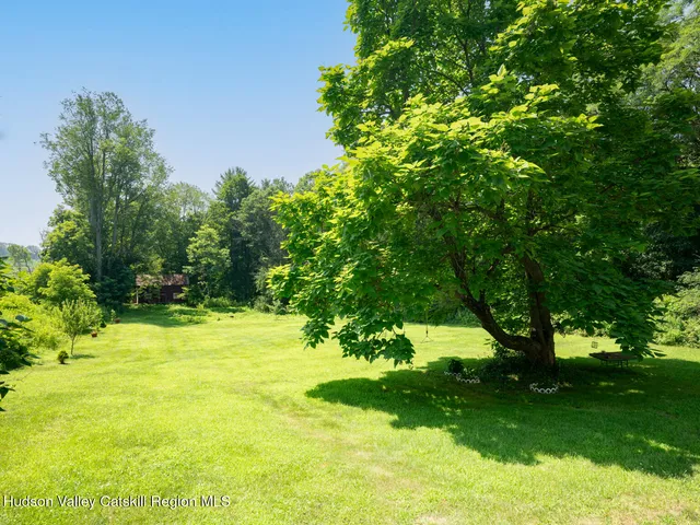 a view of a patio with table and chairs potted plants with wooden floor and fence