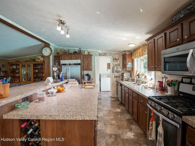 a kitchen with stainless steel appliances granite countertop a stove oven and a sink