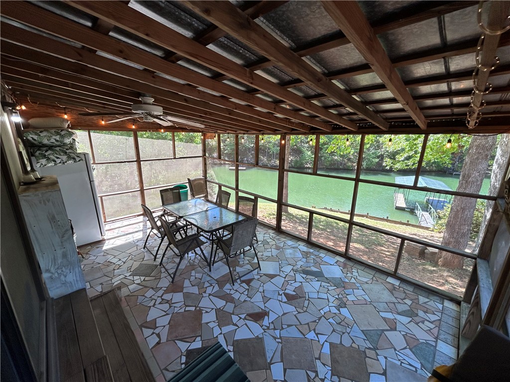43 Sunset Cove Road Abbeville, SC 29620 - Photo 21 of 41 Enjoy tranquil water views from this expansive screened porch, perfect for seamless indoor-outdoor living.