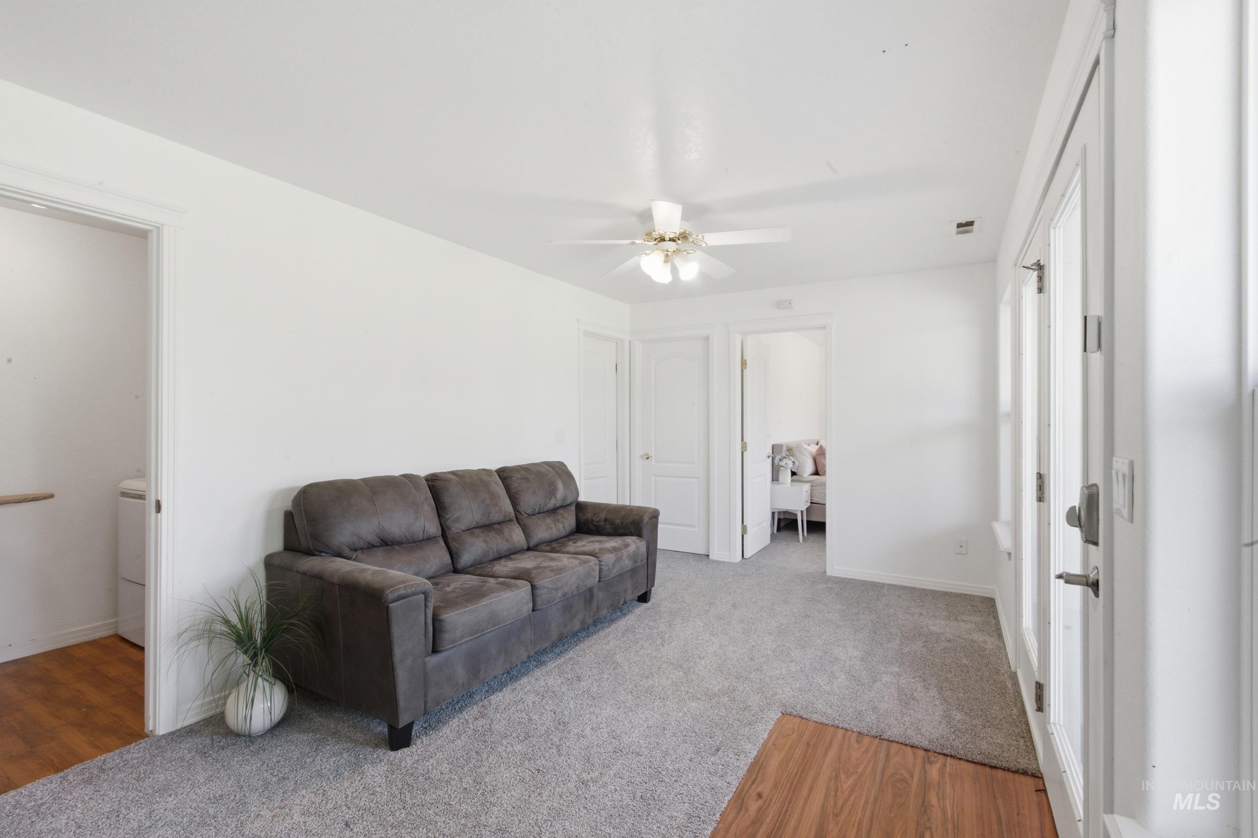 7781 Redmon Road Caldwell, ID 83607 - Photo 22 of 50 Spacious living area featuring light wood-finish flooring, a contemporary ceiling fan, and recessed lighting