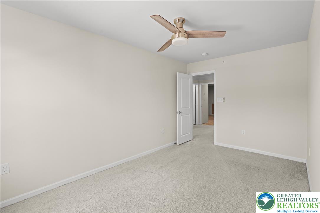 4758 Rafi Road Easton, PA 18045 - Photo 31 of 55 A well-lit room awaits with neutral-toned walls and comfortable carpeting, ready for personalization.