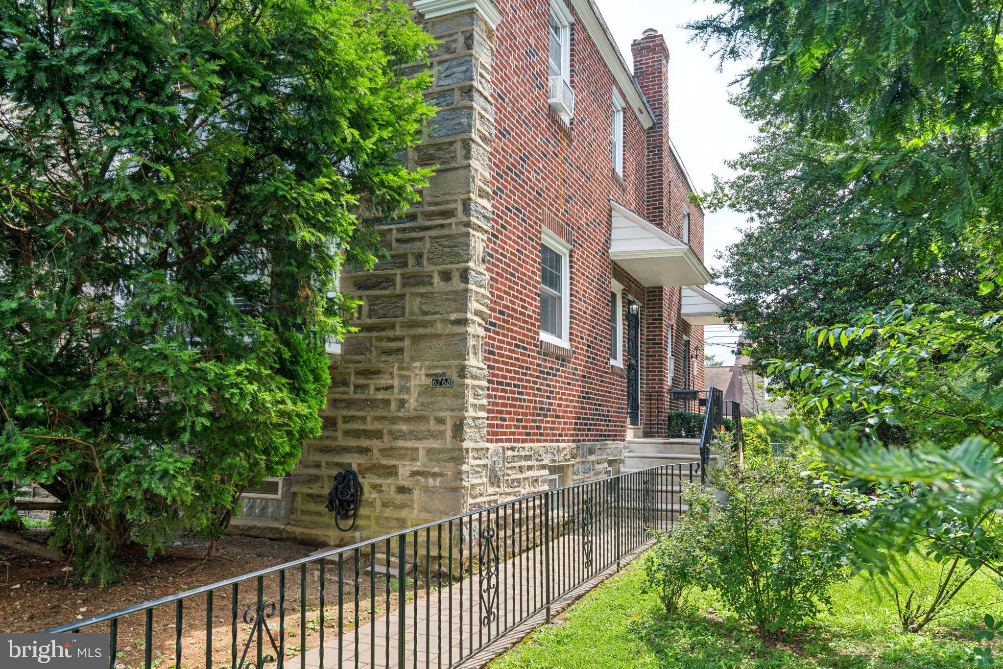 6768 Stenton Avenue Philadelphia, PA 19119 - Photo 12 of 76 a view of a brick building next to a yard
