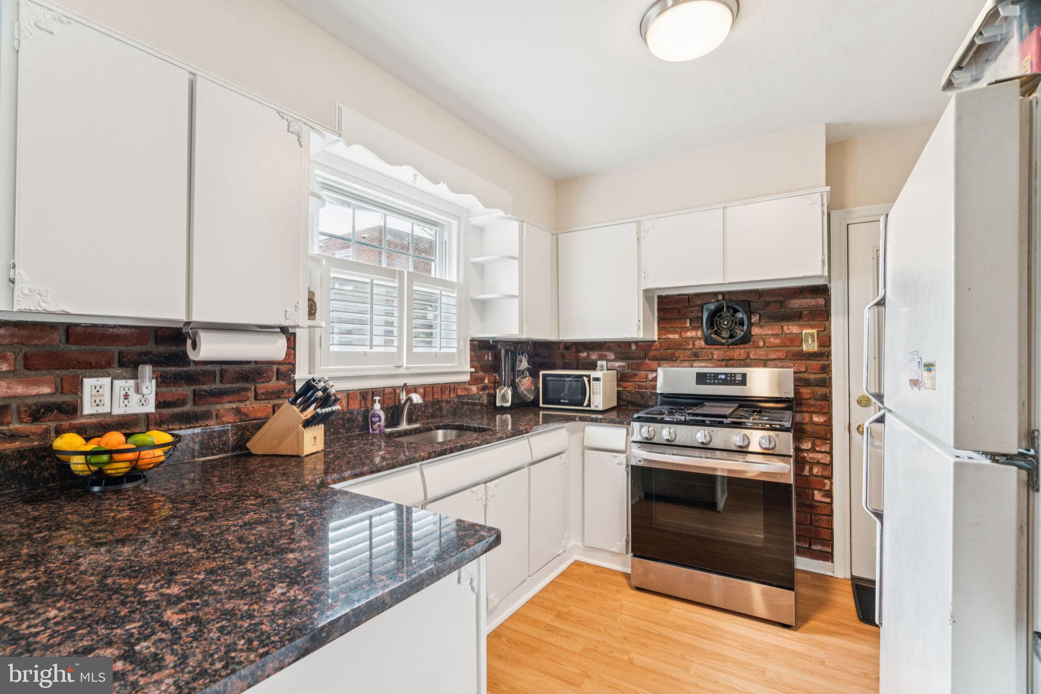 6768 Stenton Avenue Philadelphia, PA 19119 - Photo 20 of 76 a kitchen with stainless steel appliances granite countertop a stove a sink and a refrigerator