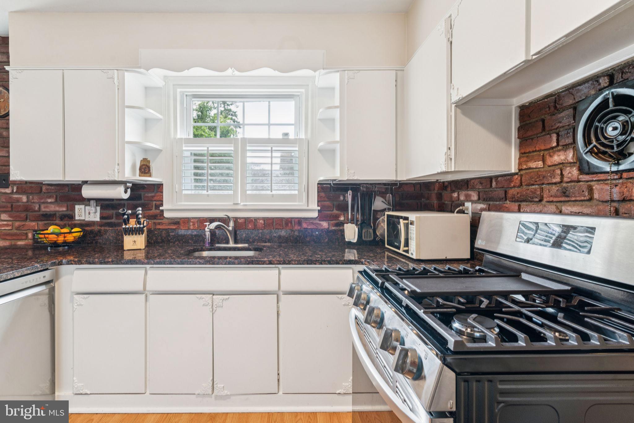 6768 Stenton Avenue Philadelphia, PA 19119 - Photo 22 of 76 a kitchen with stainless steel appliances granite countertop a stove and a sink