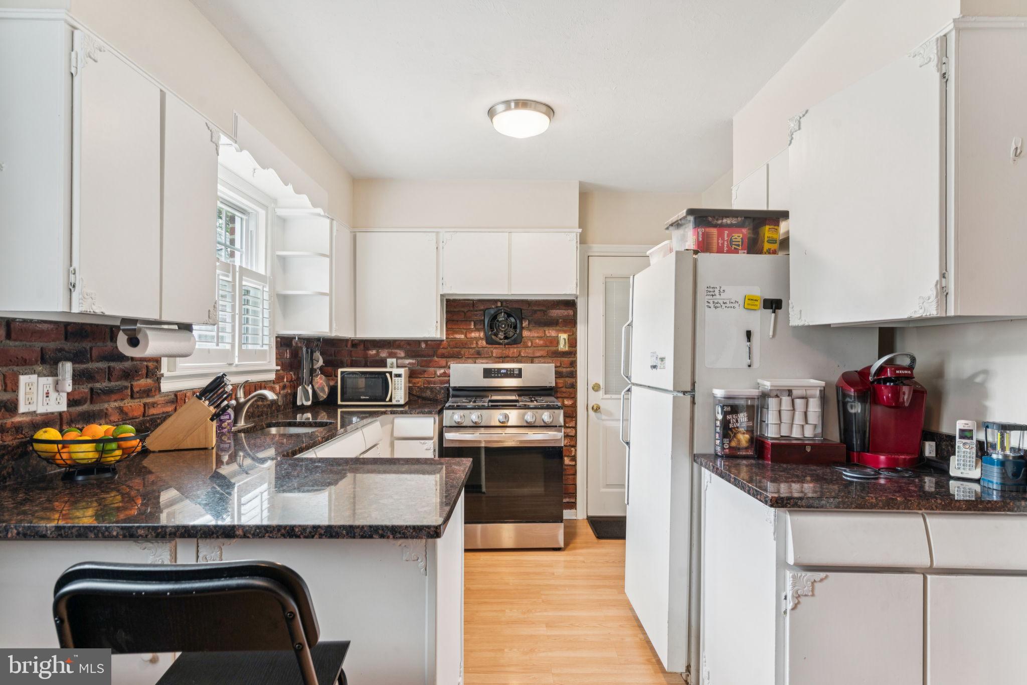 6768 Stenton Avenue Philadelphia, PA 19119 - Photo 23 of 76 a kitchen with refrigerator and cabinets