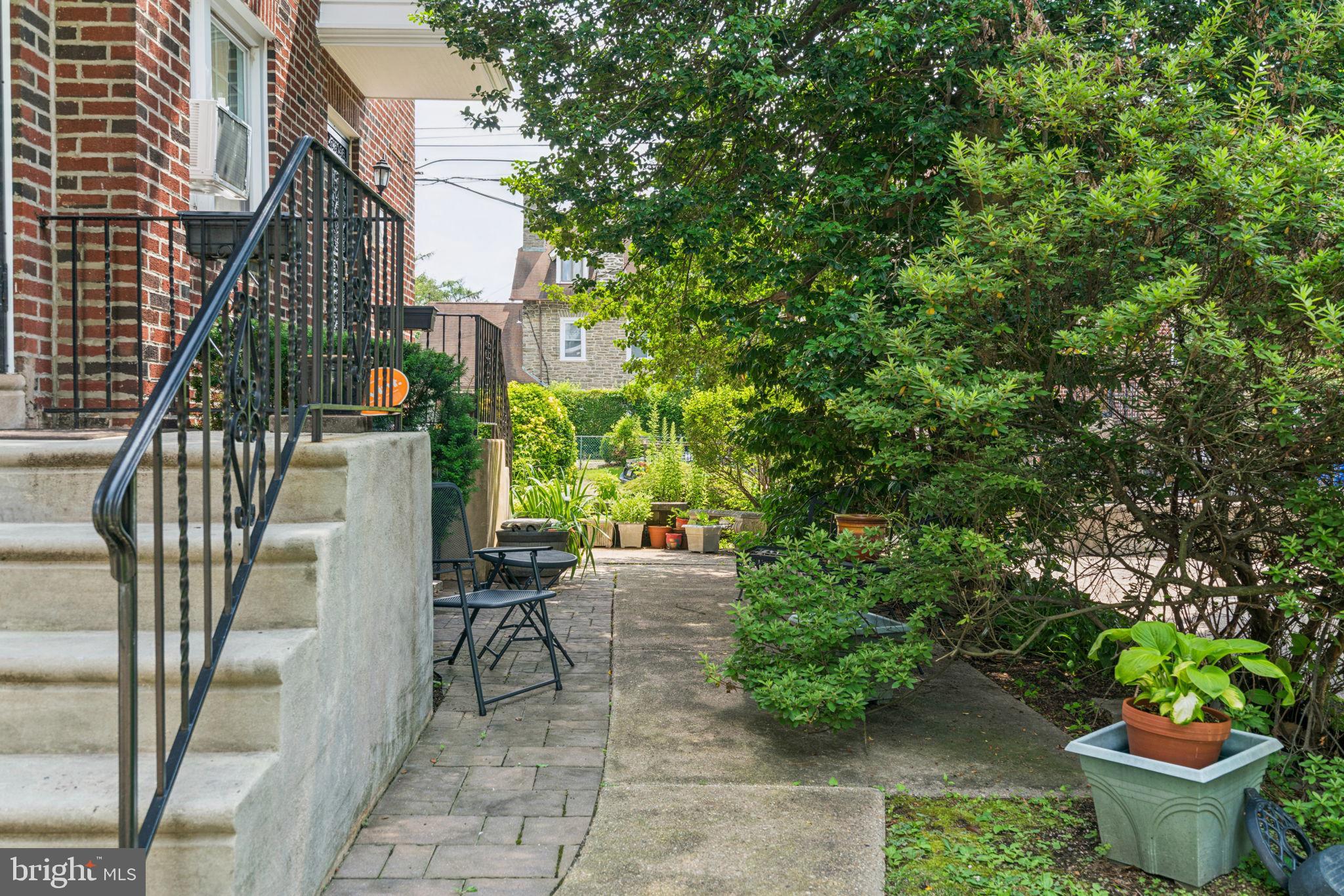 6768 Stenton Avenue Philadelphia, PA 19119 - Photo 27 of 76 a view of a patio with table and chairs potted plants and large tree