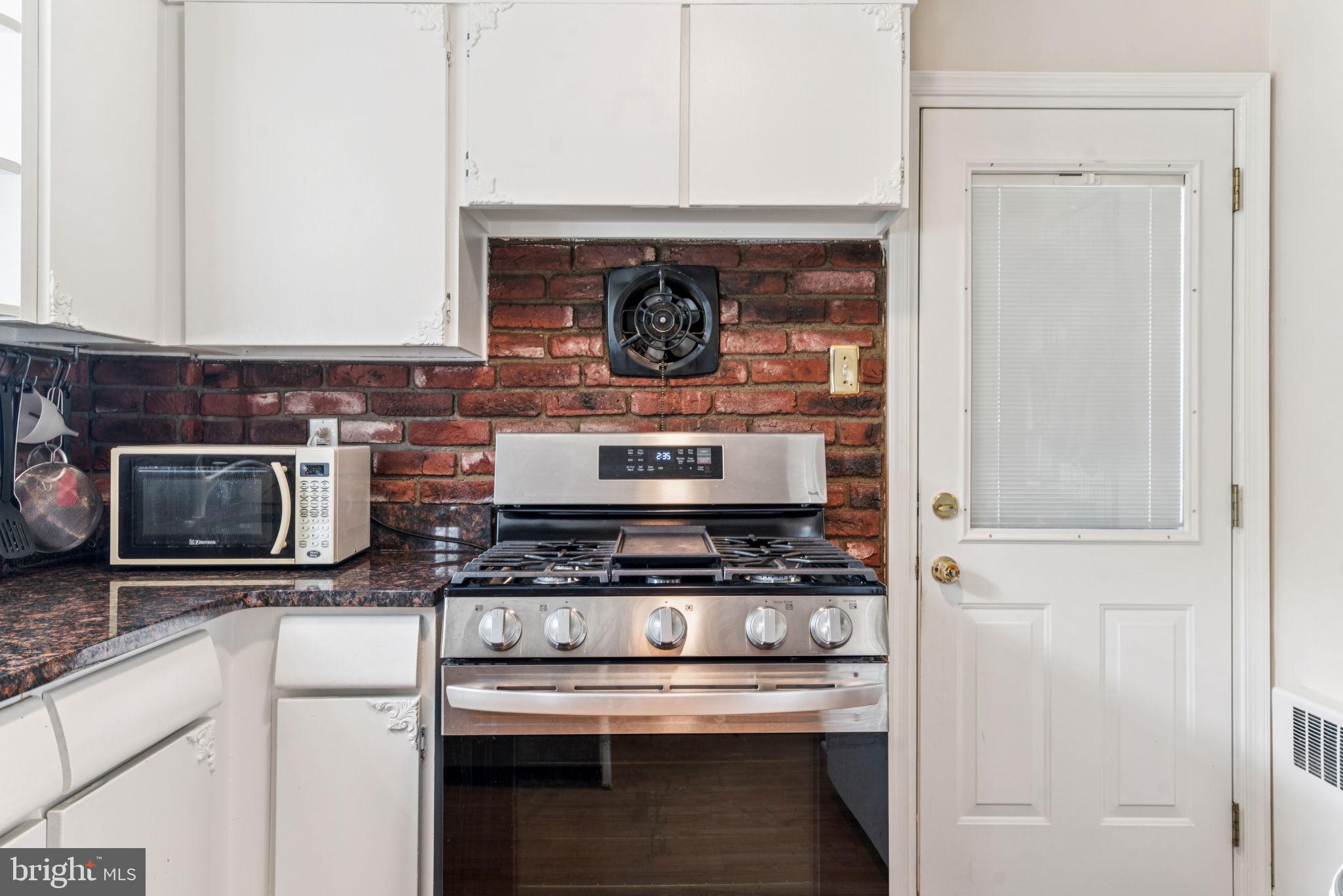 6768 Stenton Avenue Philadelphia, PA 19119 - Photo 31 of 76 a stove top oven sitting inside of a kitchen
