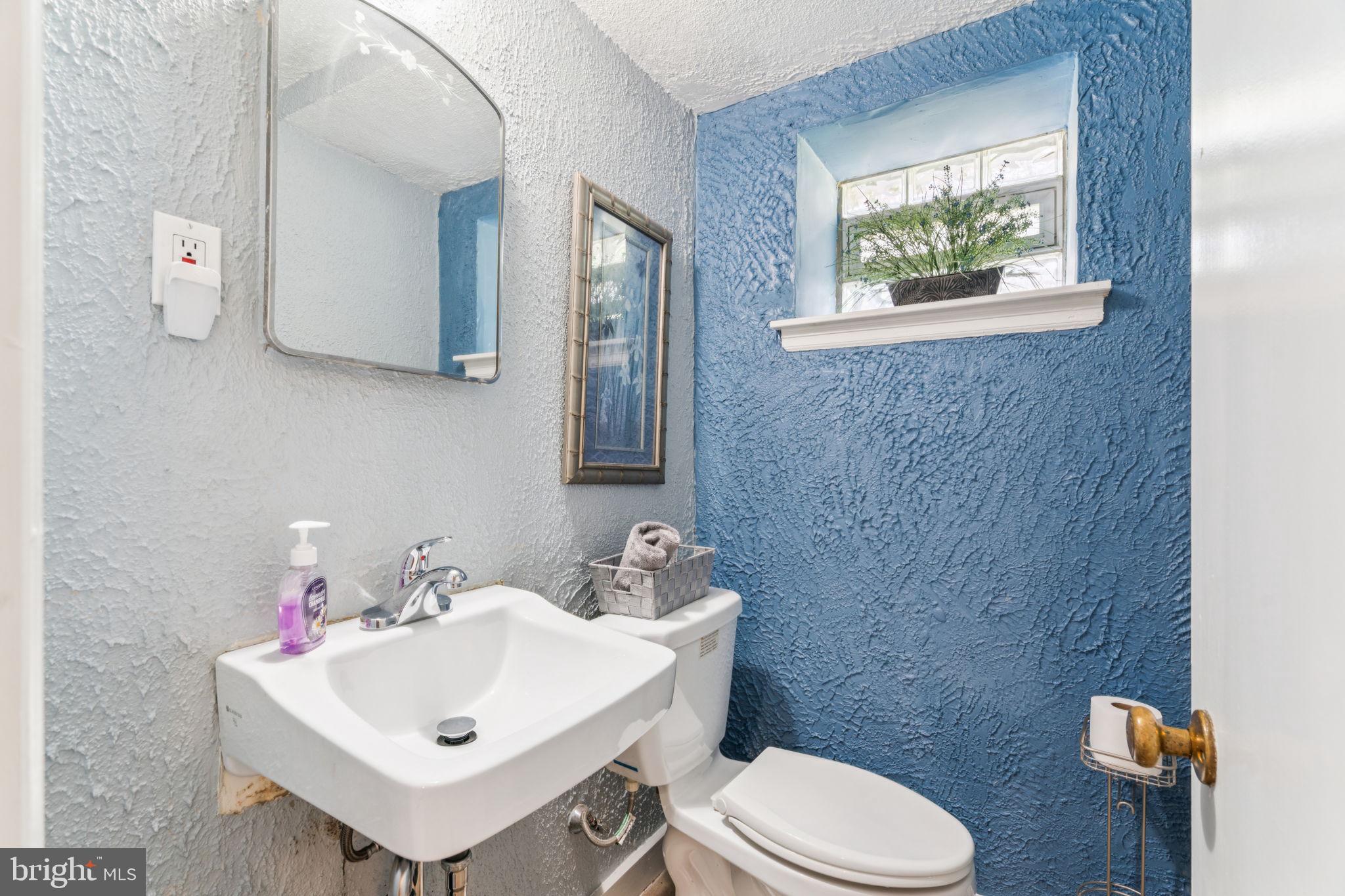 6768 Stenton Avenue Philadelphia, PA 19119 - Photo 43 of 76 a bathroom with a sink mirror and toilet