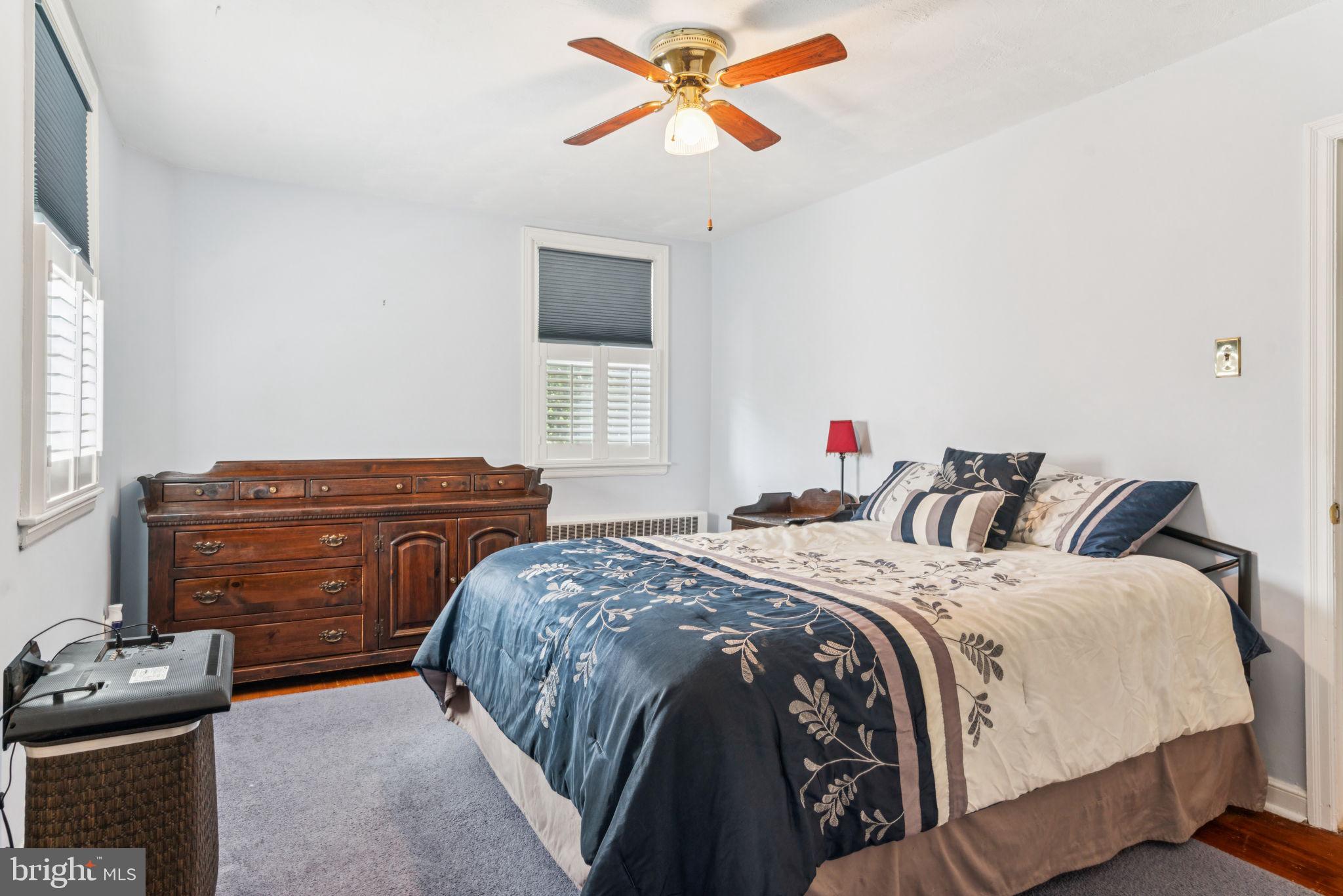 6768 Stenton Avenue Philadelphia, PA 19119 - Photo 44 of 76 a bedroom with a bed and a ceiling fan