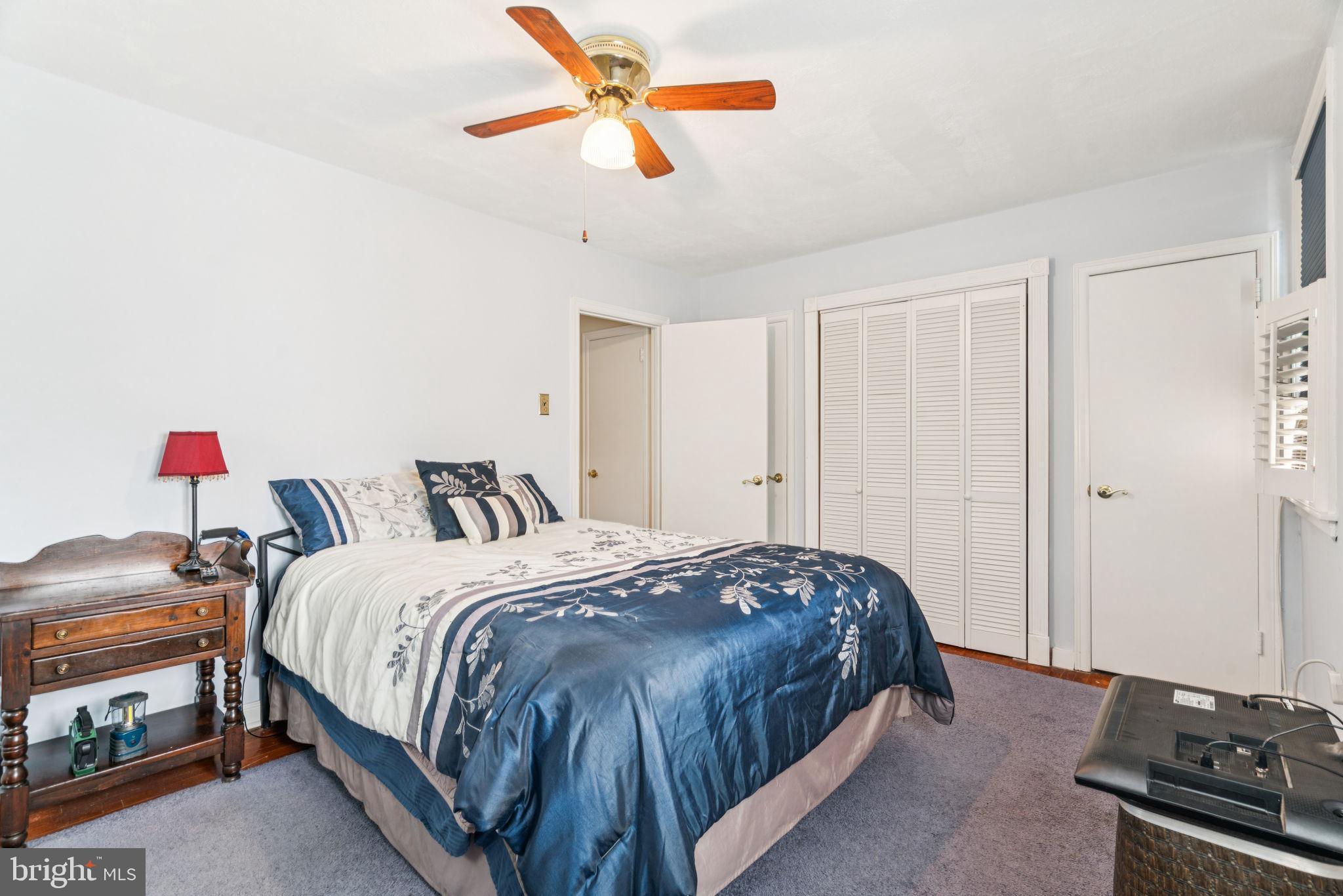 6768 Stenton Avenue Philadelphia, PA 19119 - Photo 47 of 76 a bedroom with a bed and a chandelier
