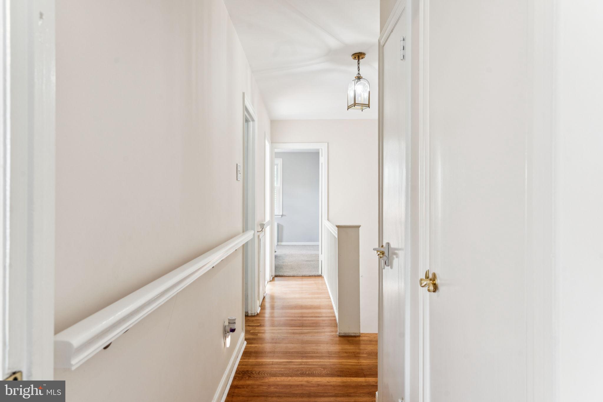 6768 Stenton Avenue Philadelphia, PA 19119 - Photo 48 of 76 a view of a hallway with wooden floor and staircase